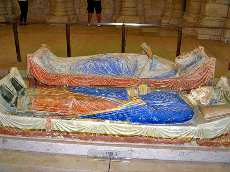 Tomb of Eleanor of Aquitaine and Henry II, featuring elaborate stone carvings and colorful details, displayed in a historical setting.
